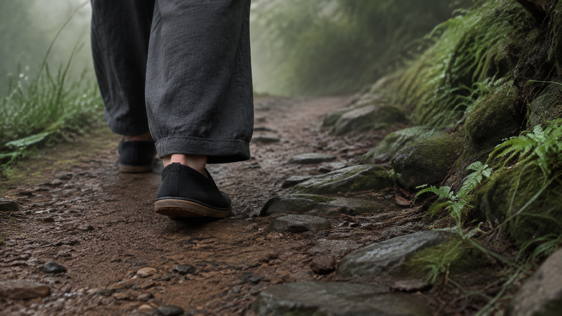 A person walking mindfully along a damp earth and stone path